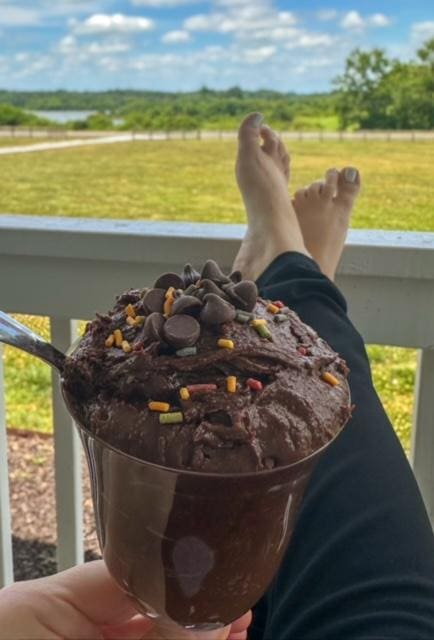 Chocolate dessert, feet up, relaxing view.