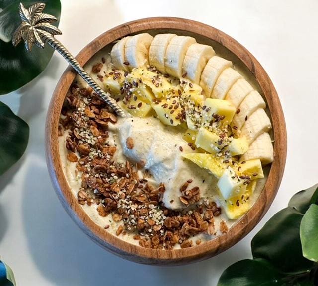 Tropical fruit smoothie bowl with granola.