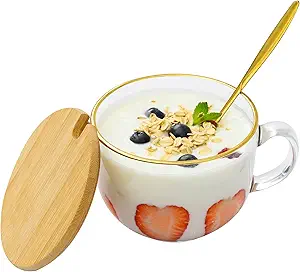 Here's an alt tag for the image: Yogurt parfait in glass mug with lid.