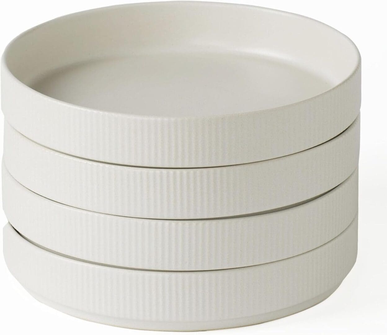 Stack of four ribbed ceramic plates.