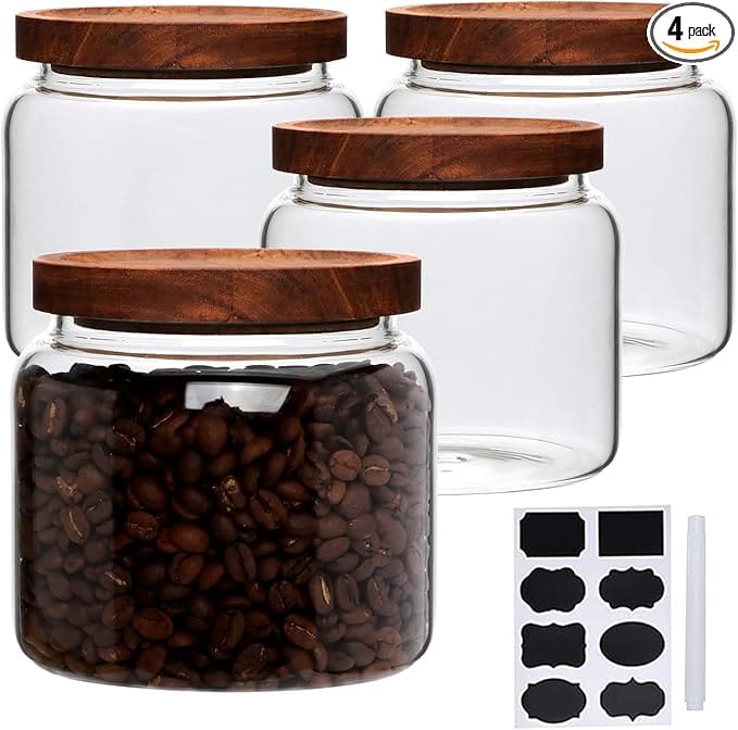 Four glass canisters with wooden lids.