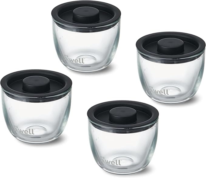 Four glass containers with black lids.