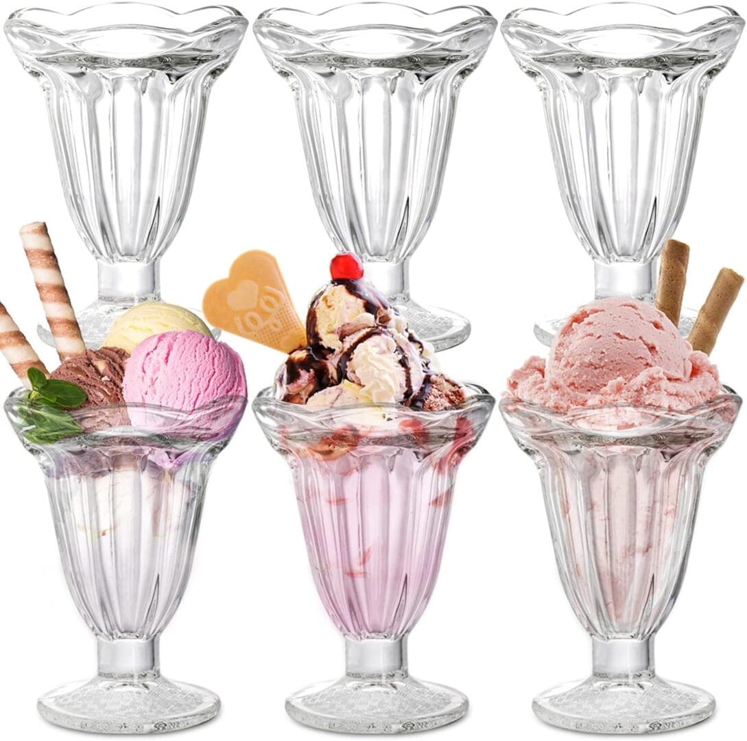 Six glass sundae dishes with ice cream.