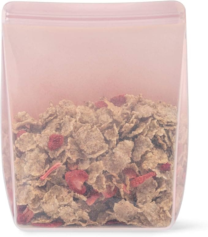 Pink silicone bag of cereal with strawberries.