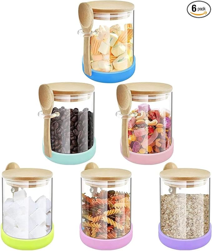 Six glass food storage jars with spoons.