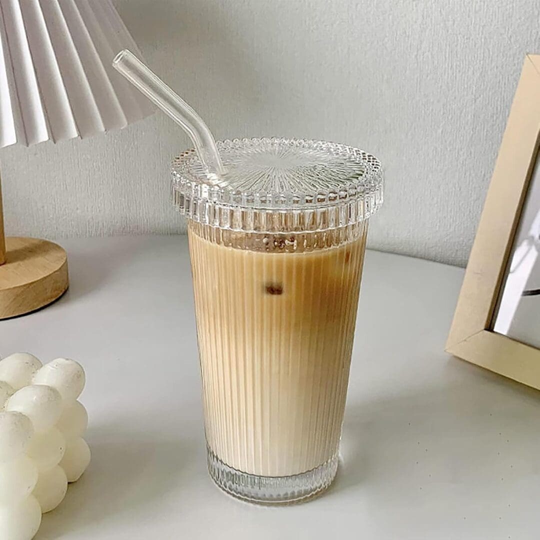 Ice coffee in ribbed glass with straw.