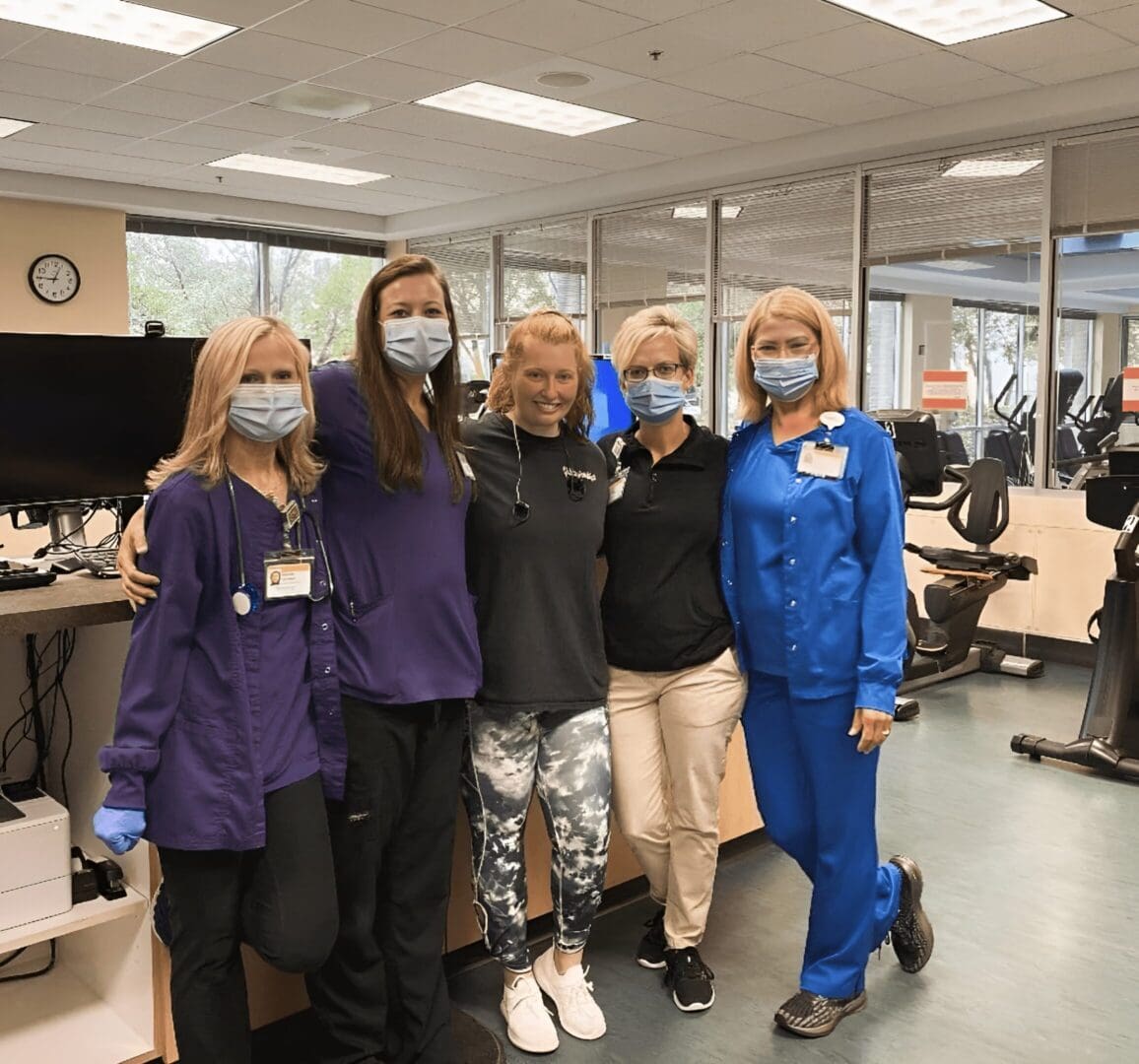 Healthcare workers wearing masks in gym.