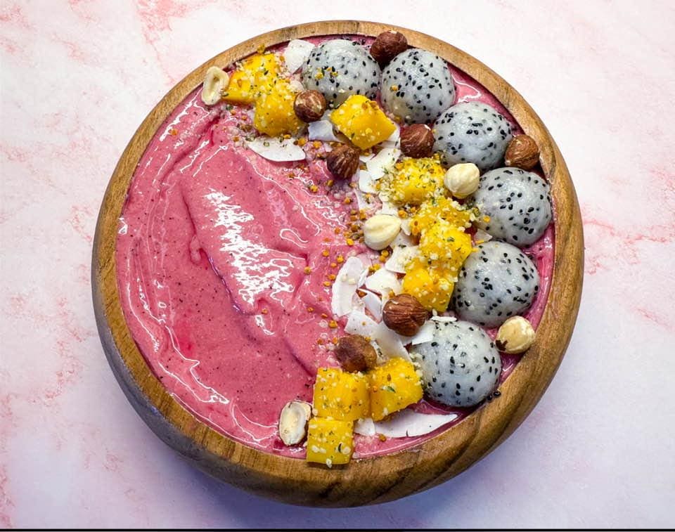 Pink smoothie bowl with dragon fruit.