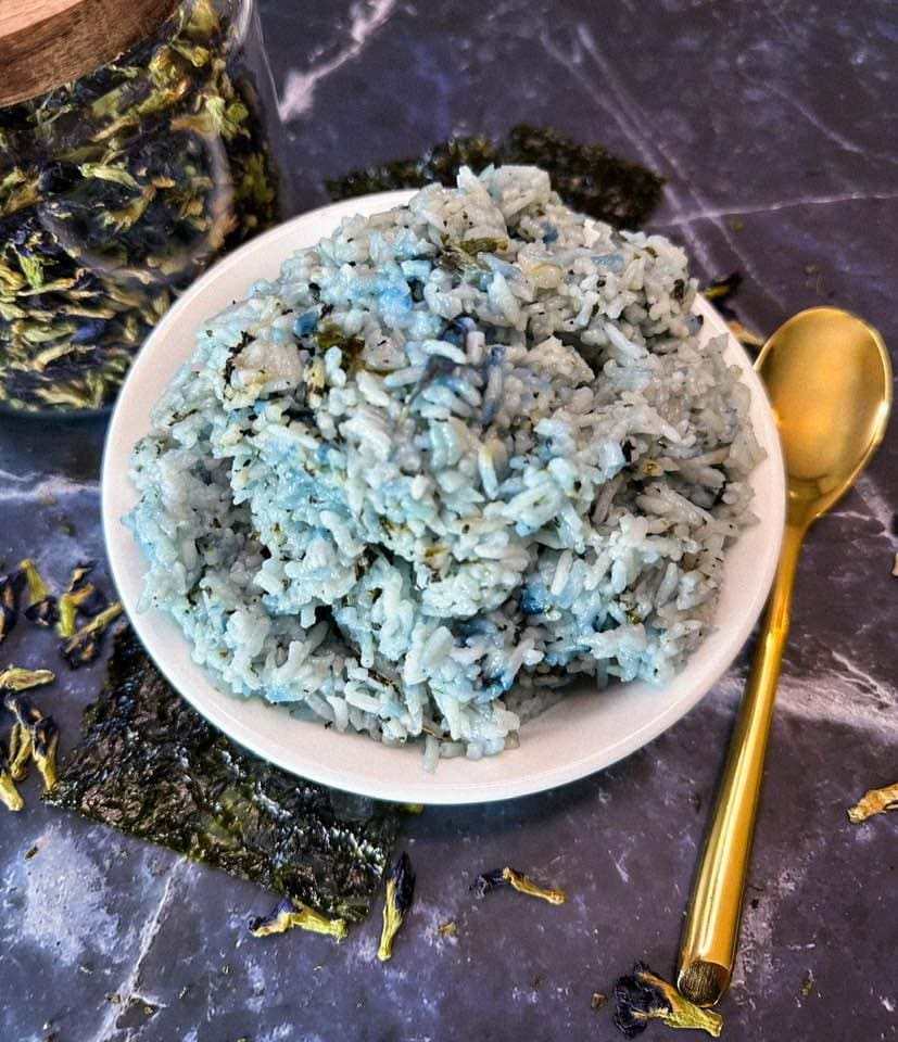 Blue rice with seaweed in a bowl.