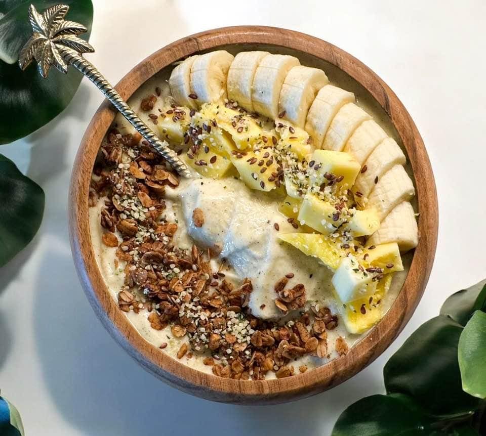 Tropical fruit smoothie bowl with granola.