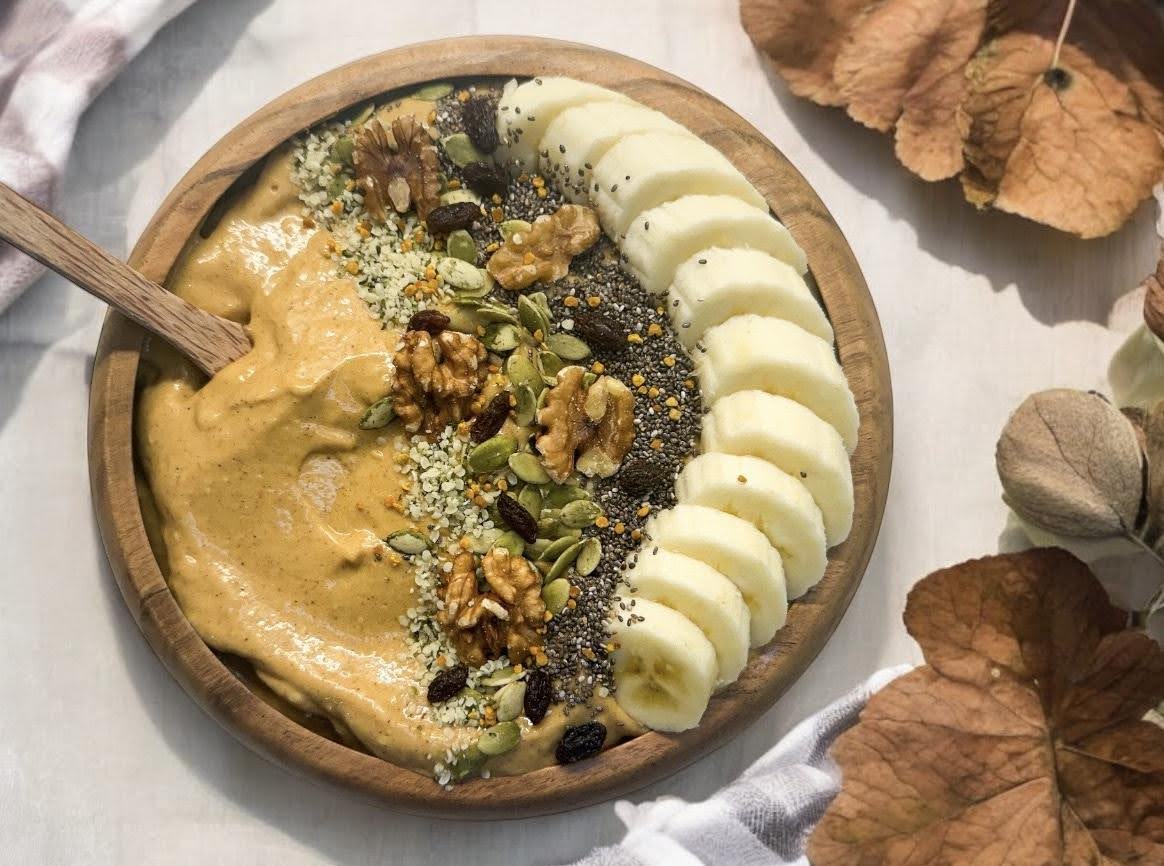 Pumpkin smoothie bowl with banana & seeds.